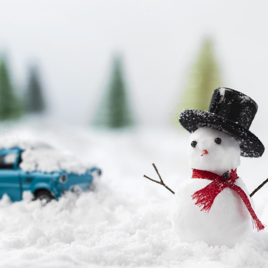 Snowman with Truck in the background Designed by Freepik